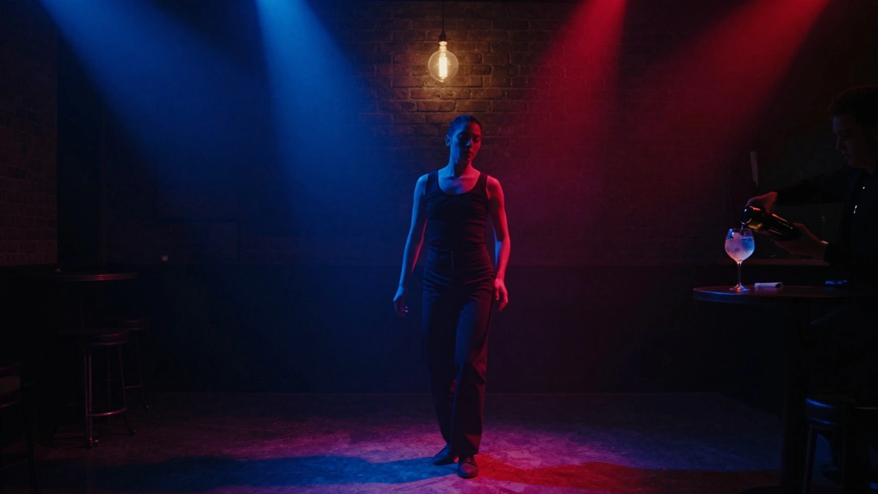A solitary dancer lost in music under soft amber light, with a gin &amp; tonic on the bar nearby in a dim, industrial club setting.
