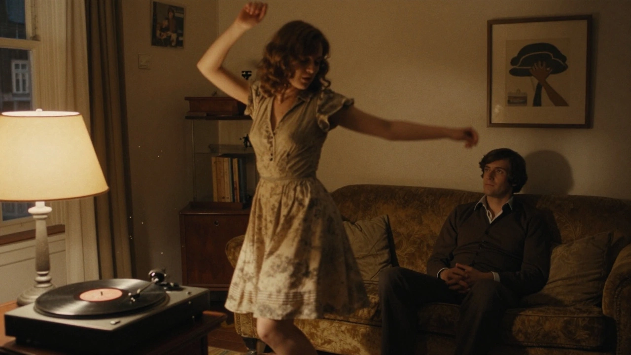 A woman dances alone in a dimly lit Amsterdam apartment, a man sitting silently on a sofa beside her.